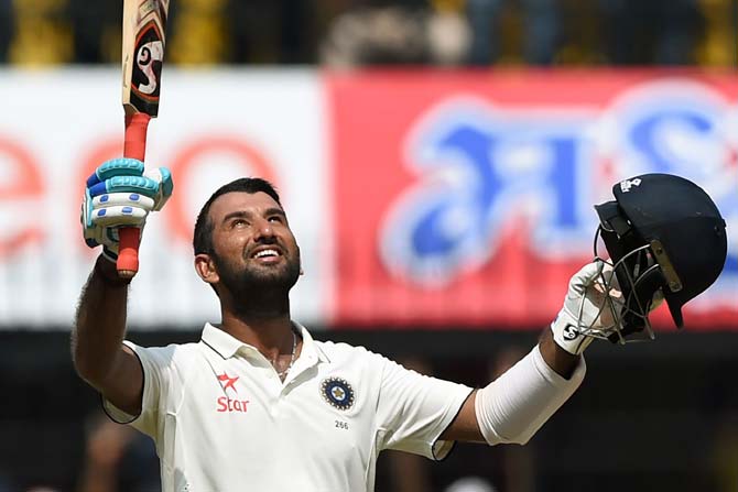 Indian batsman Cheteshwar Pujara celebrates after scoring a century during the fourth day of third Test against New Zealand. Pic/ PTI