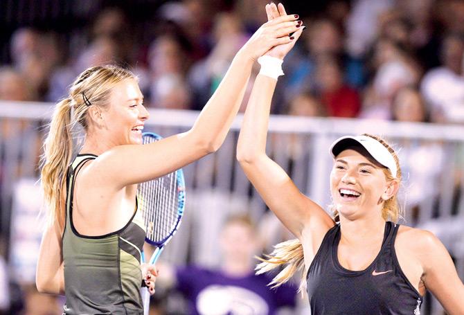 Maria Sharapova (left) and Taylor Johnson share a light moment during a charity event in Las Vegas, Nevada on Monday. Pic/AFP
