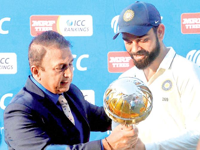Sunil Gavaskar presents the ICC Test Championship mace to Indian skipper Virat Kohli in Indore yesterday. Pic/PTI