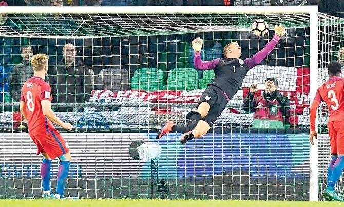 England goalkeeper Joe Hart (centre) makes a save during the World Cup qualifier against Slovenia in Ljubljana on Tuesday. Pic/AFP