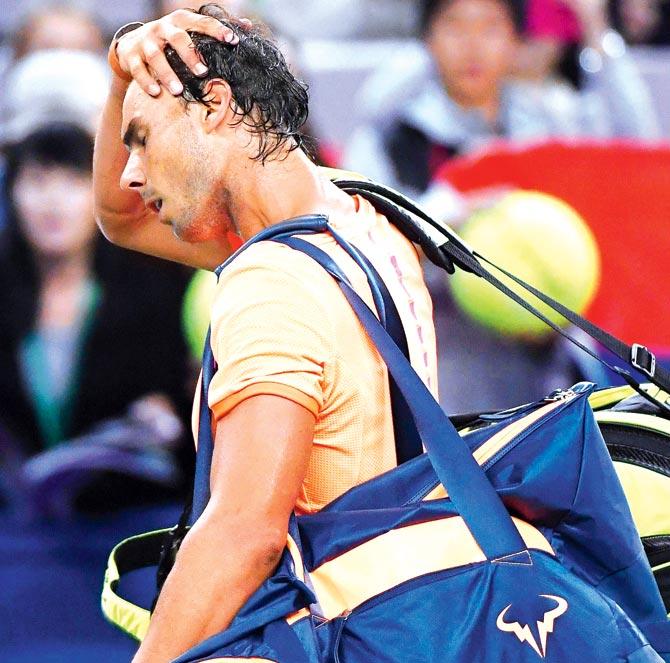 Rafel Nadal leaves the court after losing to Serbain Viktor Troicki in Shanghai yesterday. Pic/AFP