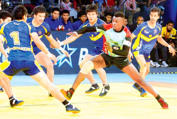 Thailand players try to tackle a Kenyan raider during the Kabaddi World Cup tie at Ahmedabad yesterday. Pic/PTI