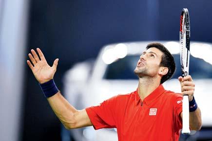 Novak Djokovic hums his way to a tense win over Mischa Zverev