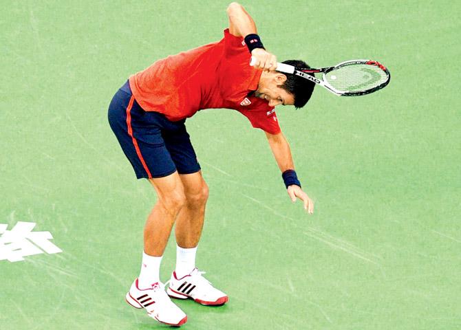 Novak Djokovic smashes his racquet after losing a point against Roberto Bautista in their semi-final at Shanghai on Saturday. Pic/AFP