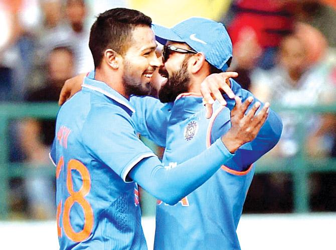 Hardik Pandya (left) celebrates with Virat Kohli after dismissing New Zealand batsman Luke Ronchi in Dharamsala yesterday. Pic/PTI