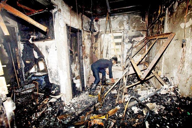 The charred remains of the home. Pic/PTI
