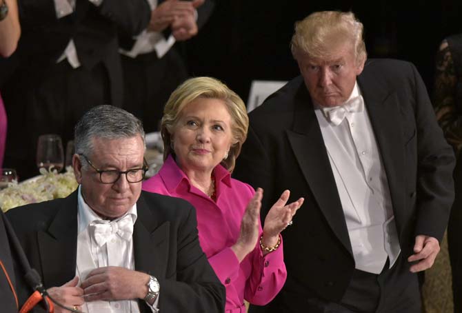 Hillary Clinton (C) applauds watched by Donald Trump during the 71st annual Alfred E. Smith Memorial Foundation Dinner. Pic/ AFP