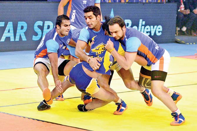 Indian defenders tackle a Thailand raider during the semi-final  of the Kabaddi World Cup in Ahmedabad yesterday. pic/PTI