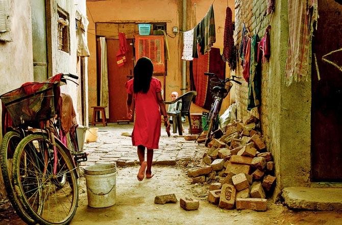 A still from Lockstitch Lives shows a young girl from a family of domestic workers in Katarpuri, Gurgaon, home to several such workers. Pic/Helmstudio  