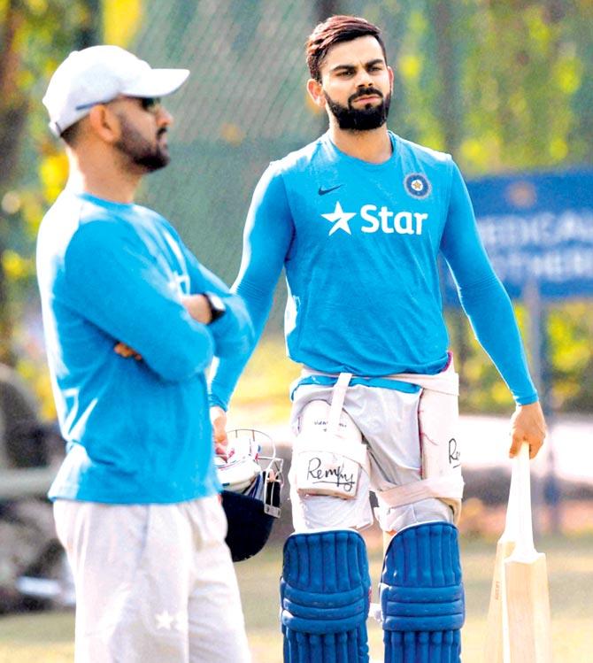 Team India skipper MS Dhoni and vice-captain Virat Kohli during a team practice session on the eve of the third ODI against New Zealand at the PCA Stadium in Mohali on Saturday. Pic/PTI