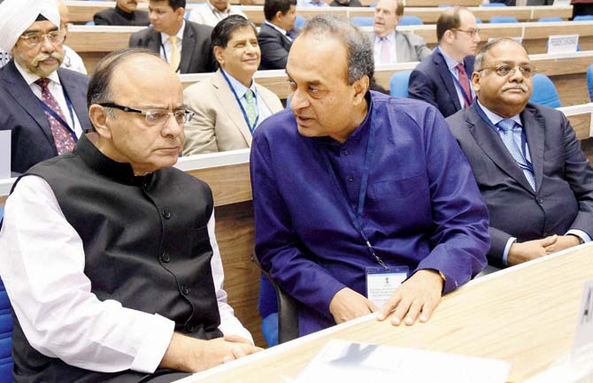 Union Finance Minister Arun Jaitley (l) listens to Attorney General Mukul Rohatgi during the inauguration of 