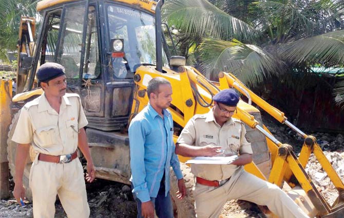 Range forest officer Sanjay Bagare at the spot where digging was being done, with JCB operator Panelal Yadav. The forest department lodged police complaints against the violation