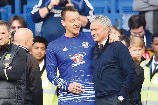 Chelsea captain John Terry (left) greets Man United manager Jose Mourinho during the EPL clash in London yesterday. Chelsea won 4-0. pic/AFP