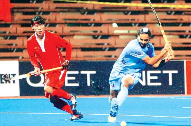 Akashdeep (left) fires a shot during the Asian Champions trophy tie vs China in Malaysia yesterday