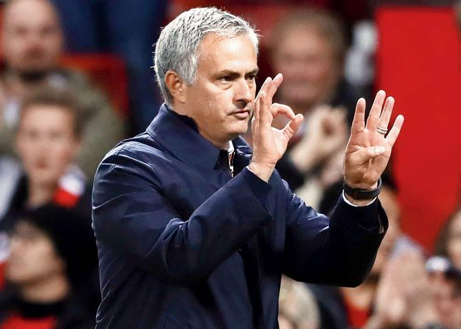 Man Utd boss Jose Mourinho gestures to his team during the match 