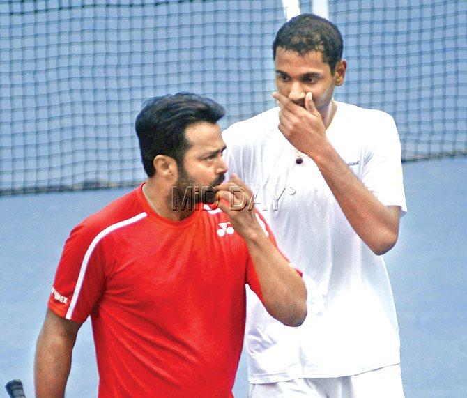Leander Paes (left) chats with partner Ramkumar Ramanathan during the first round of the ATP Challenger event at the Shiv Chhatrapati Sports Complex in Pune yesterday. Pic/Pradeep Dhivar