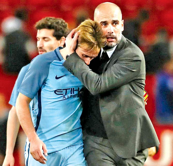 City manager Pep Guardiola consoles Aleix Garcia after the defeat