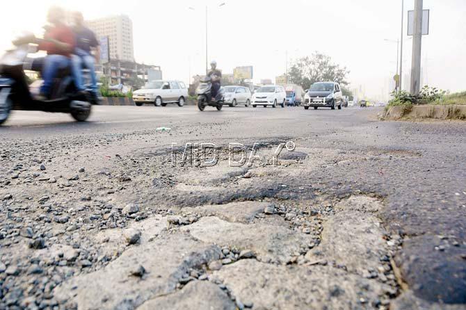 Potholes on the Western Express Highway continue to give a bumpy ride to commuters. Pics/Bipin Kokate