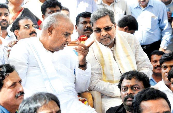 Karnataka Chief Minister Siddaramaiah meets JD(S) Supremo HD Devegowda during a protest regarding the Cauvery issue in Bengaluru on Saturday. Pic/PTI