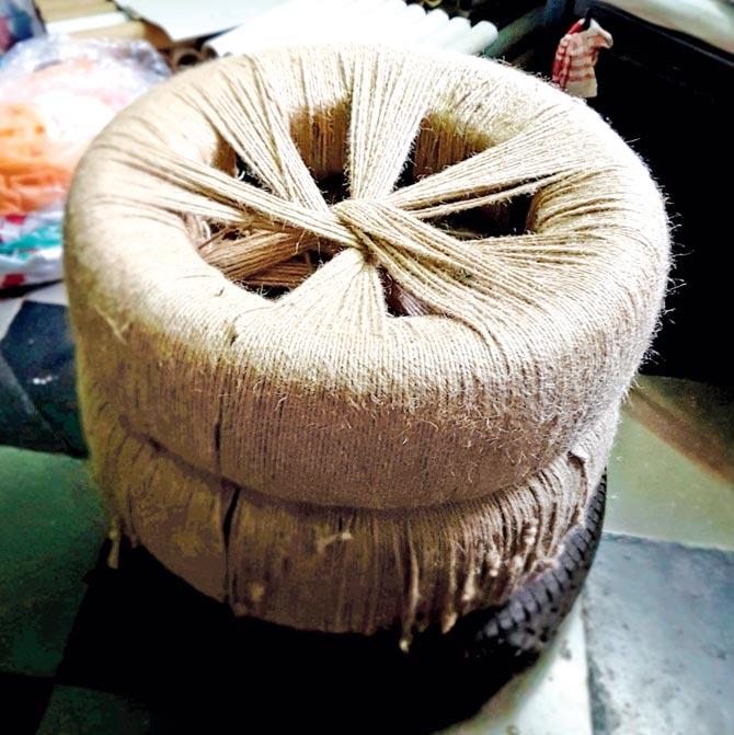 Used rubber tyres repurposed for a stool, wound with coir ropes on sale at the Mela