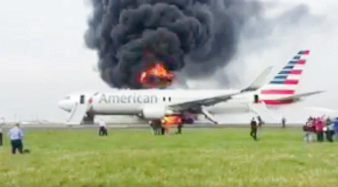 Dark smoke billows from the plane in Chicago airport. Pic/twitter