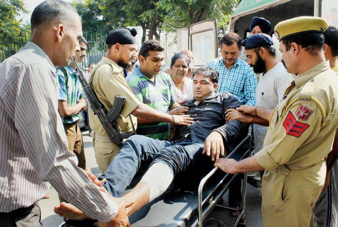 A villager is shifted to the Government Medical Hospital in Jammu  after he was injured in cross-border firing in RS Pura sector. Pic/PTI