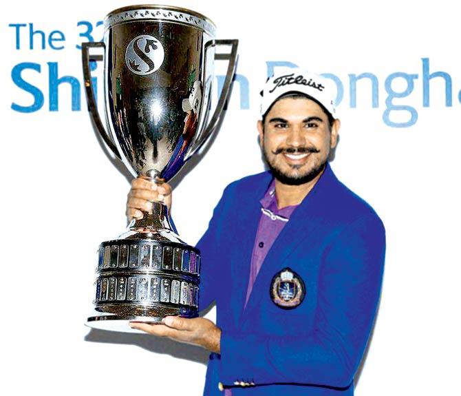 Ganganjeet poses with the trophy after his win yesterday. Pic/PTI