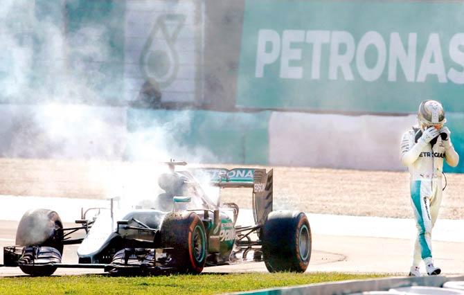 Lewis Hamilton retires from the Malaysian Grand Prix after his engine catches fire in Sepang yesterday