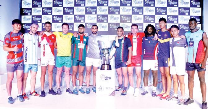 Captains of the 12 competing nations pose with the trophy during the opening ceremony of the Kabaddi World Cup in Ahmedabad yesterday