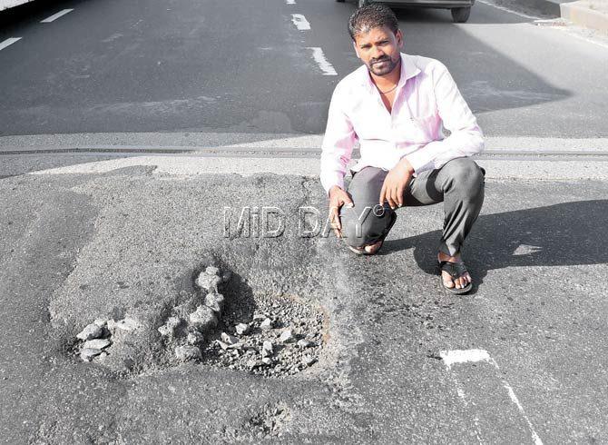 Vakola resident Atul Tambe shows the pothole on Andheri flyover that nearly killed him and his friend on Wednesday. Pic/Sameer Markande