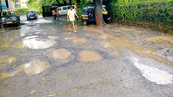 Potholes cover a road near Mysore Colony in Chembur. Residents allege that the poor upkeep of roads and traffic logjams are responsible for a number of accidents
