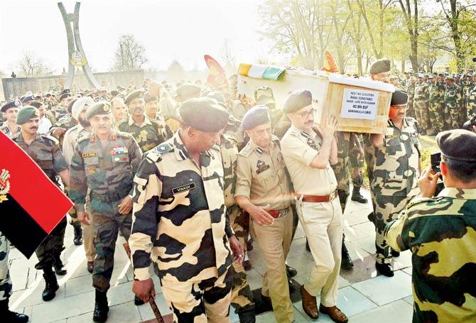 BSF and police personnel carry the coffin of Constable Nitin Kumar, who was martyred in the Baramulla attack. Pic/PTI