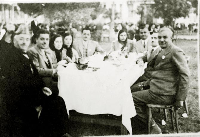 An undated photograph of Bhakti Mehta Khatri’s grandparents (seated at the head of the table), enjoying a meal with friends and family in Cairo