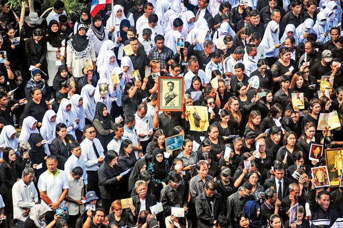 People hold up pictures of the late Thai King Bhumibol Adulyadej during a gathering at the southern province of Narathiwat. Pic/AFP