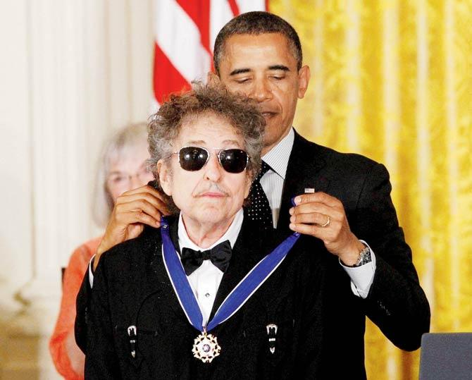 Barack Obama presented Bob Dylan with a Medal of Freedom in 2012. Pic/AP