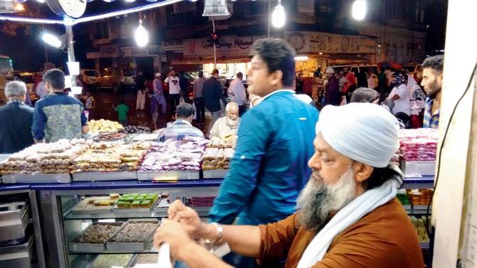 Md Farookhbhai Mithaiwala (in white turban) is busy manning the counter on most nights