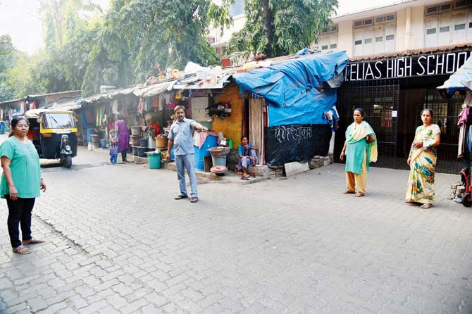 File pic of slums swallowing footpaths outside the school, forcing kids to walk on the road