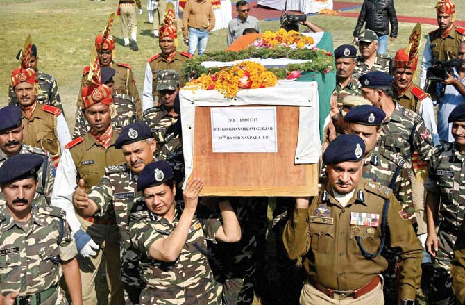 Senior officers carry the coffin of Ghanshyam Gurjar who died in the Zakura attack. Pic/PTI