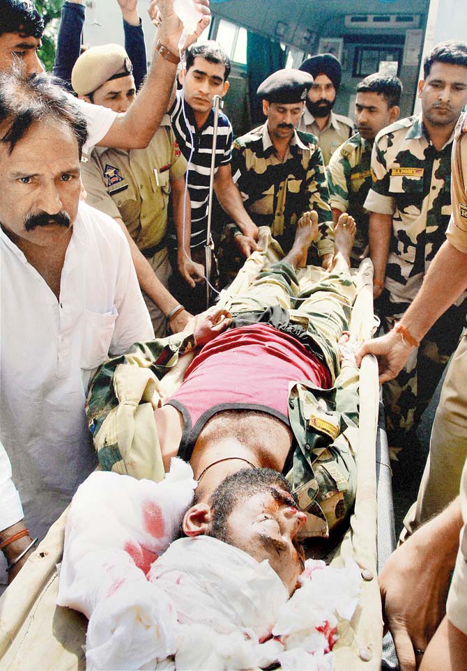 Constable Gurnam Singh while being evacuated. Pic/PTI