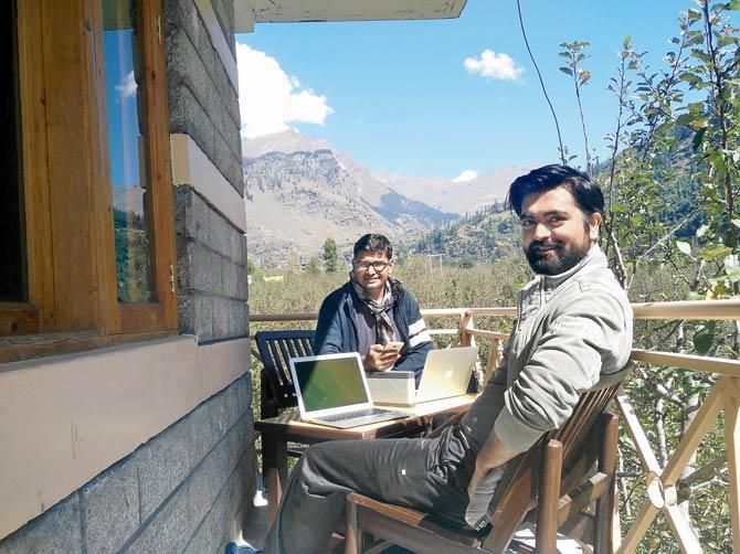 Harsh Snehanshu (left)âu00c2u0080u00c2u0088and Ashish Singh at their balcony office in Solang Valley in Himachal Pradesh