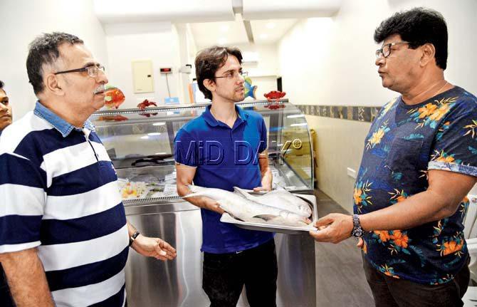 (Left to right) Off the Hook’s Firdosh and Junaid Daruwalla talk fish with Francis Fernandes