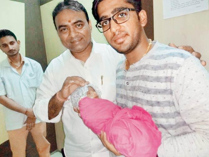 Mayank Agarwal holds the newborn in his arms at the hospital, as local corporator Anil Virani looks on. Pics/Hanif Patel