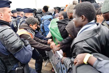Migrants, refugees march out of Calais 'Jungle' camp