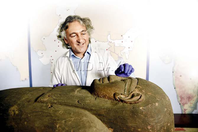 Anupam Sah points to the distinct make-up on the face of the wooden coffin, some of which is still intact. He also felt that the face on the coffin could be a man’s. Pics/Pradeep Dhivar