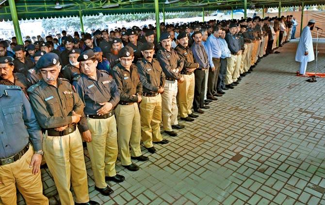 Pakistani policemen offer absentia funeral prayers for the victims of a militant attack on the Balochistan Police College, in Lahore. Pic/AFP