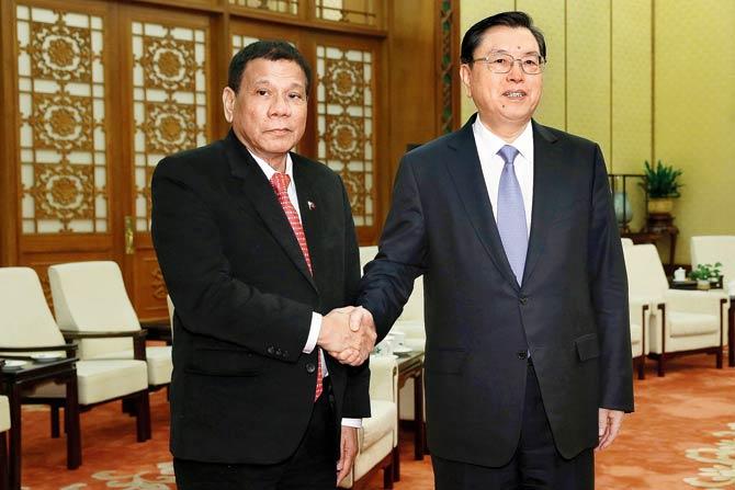 Duterte with standing committee of National People’s Congress of China chairman. Pic/AFP