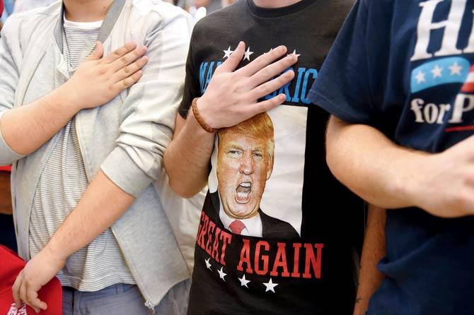 Supporters say the pledge of allegiance at the Trump rally in Nevada. Pic/ AFP