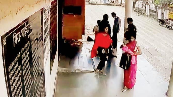 CCTV grabs show two women walking out of Rajiv Gandhi hospital in Mira Road with a baby swaddled in the same pink cloth, as seen below