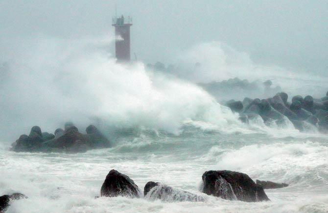 Large waves caused by Typhoon Chaba pound the coast in the southeastern city of Ulsan in South Korea. Pic/AFP