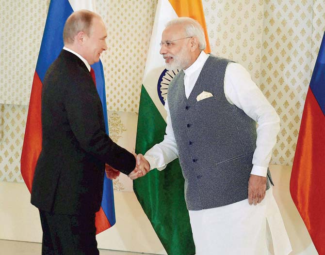 Russian President Vladimir Putin with PM Modi at Benaulim. Pic/PTI